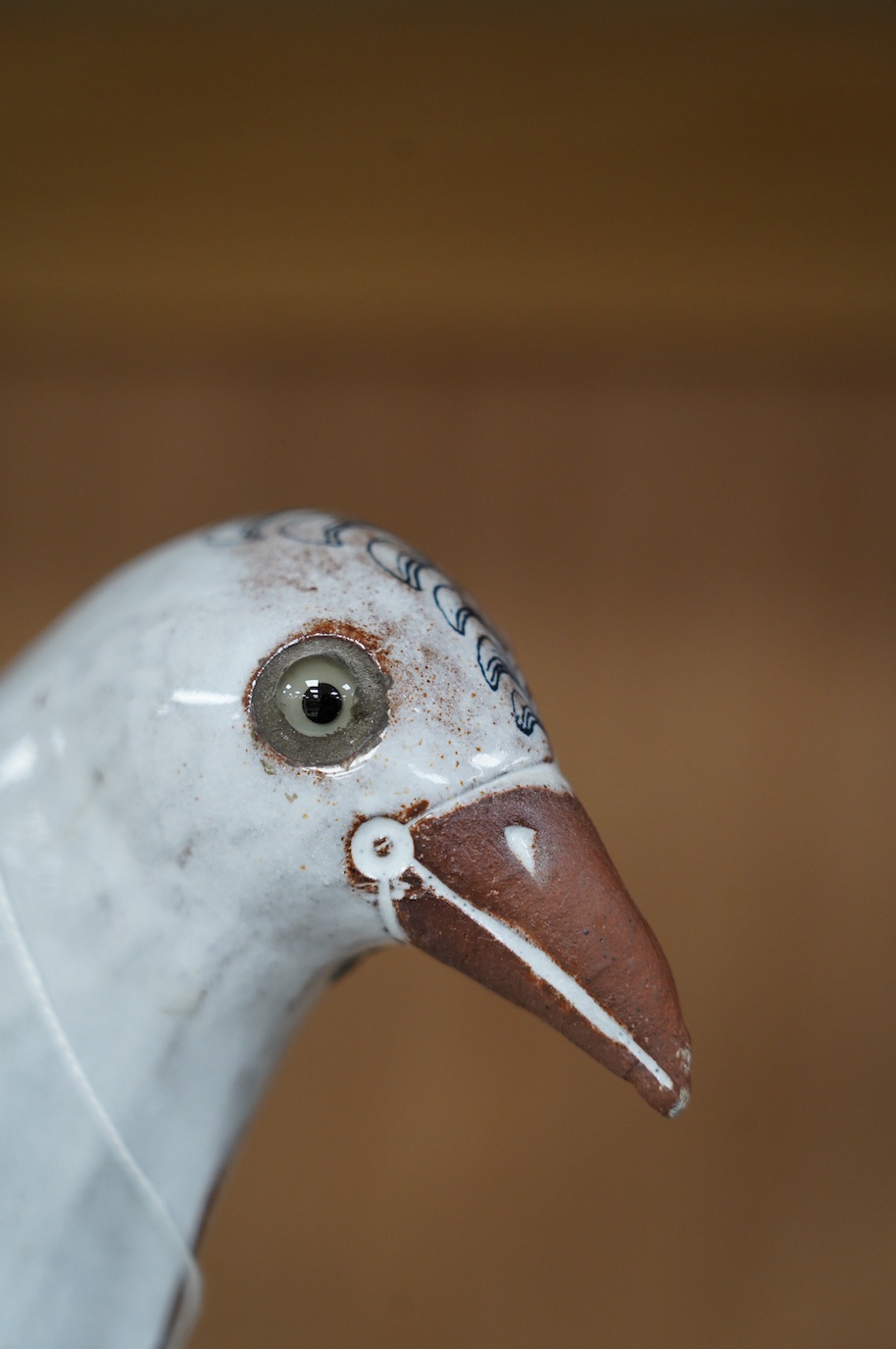 Marion Brandis (Modern British), a partially tin glazed art pottery model of a bird, 28cm tall. Condition - good